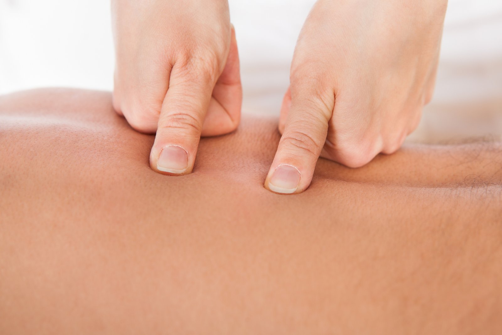 Close-up Of Person Receiving Shiatsu Treatment From Massager